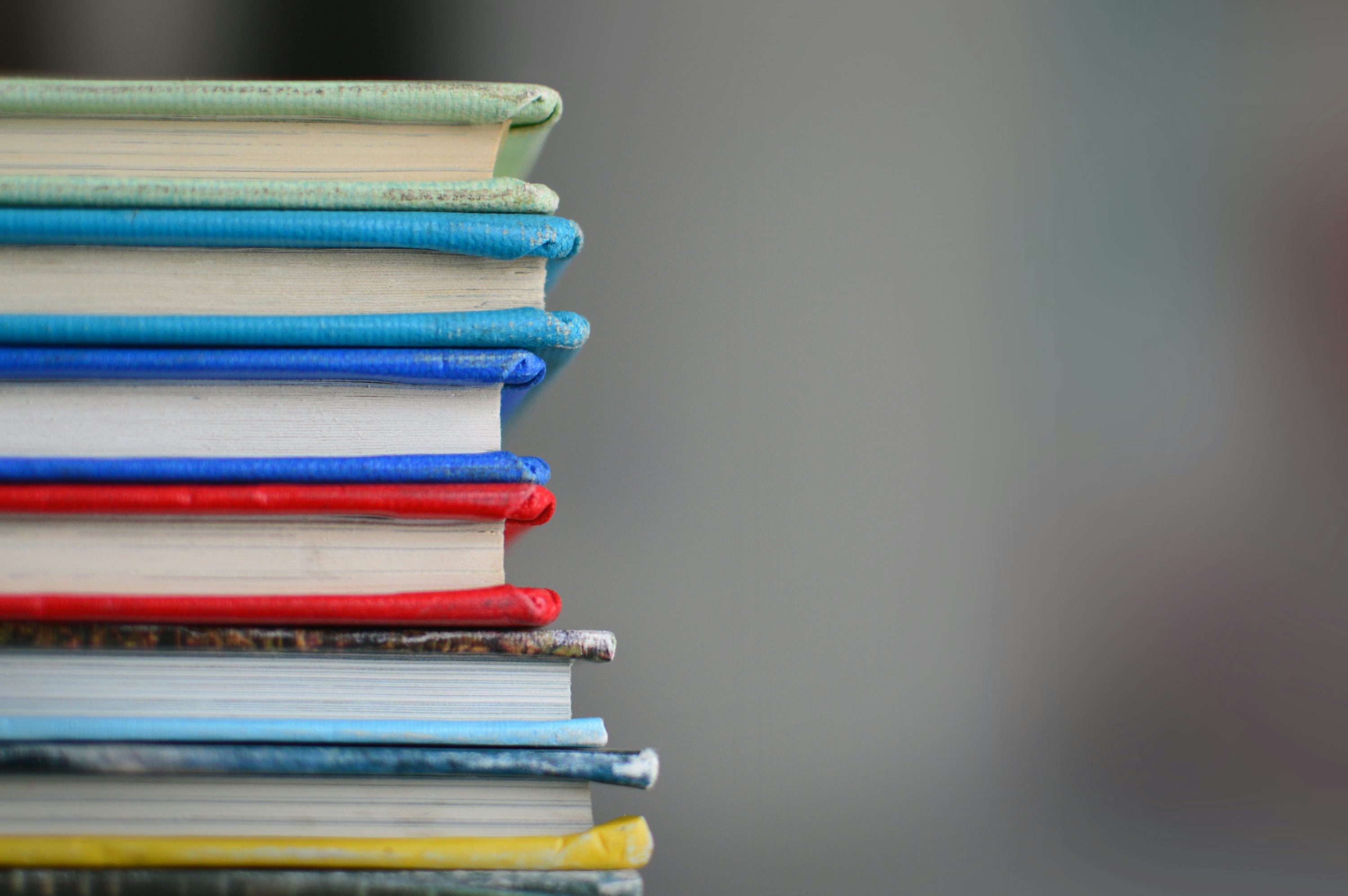 A stack of books with colorful cloth covers.